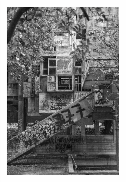 Graffiti-covered staircase leading to a building with multiple windows, Black and white fine art photograph of Giuseppe Perugini's modular, cubic modernist architecture: Casa Sperimentale in Italy.