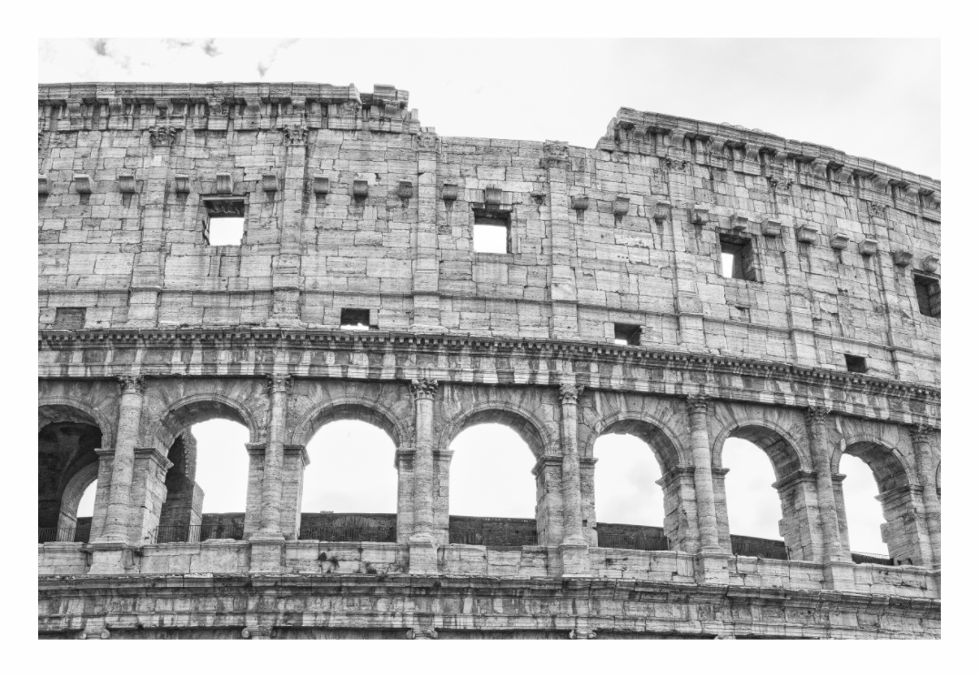 Black and white photograph of a classical architectural structure with arches, black and white Colosseum print in minimalist living room, ancient Rome arches on gray wall, moody historical photography, modern beige sofa decor, Scandinavian interior styling