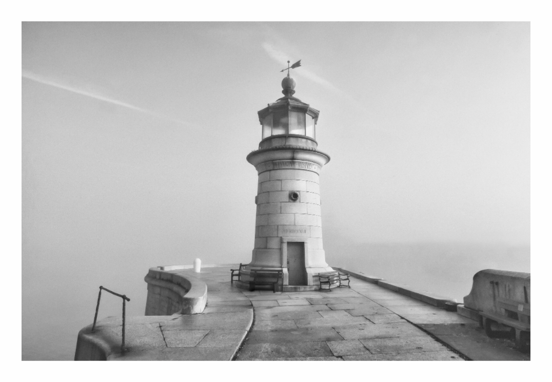Lighthouse on a foggy day with a clear sky,Black and white fine art print of the tall, historic Ramsgate Lighthouse in the United Kingdom.