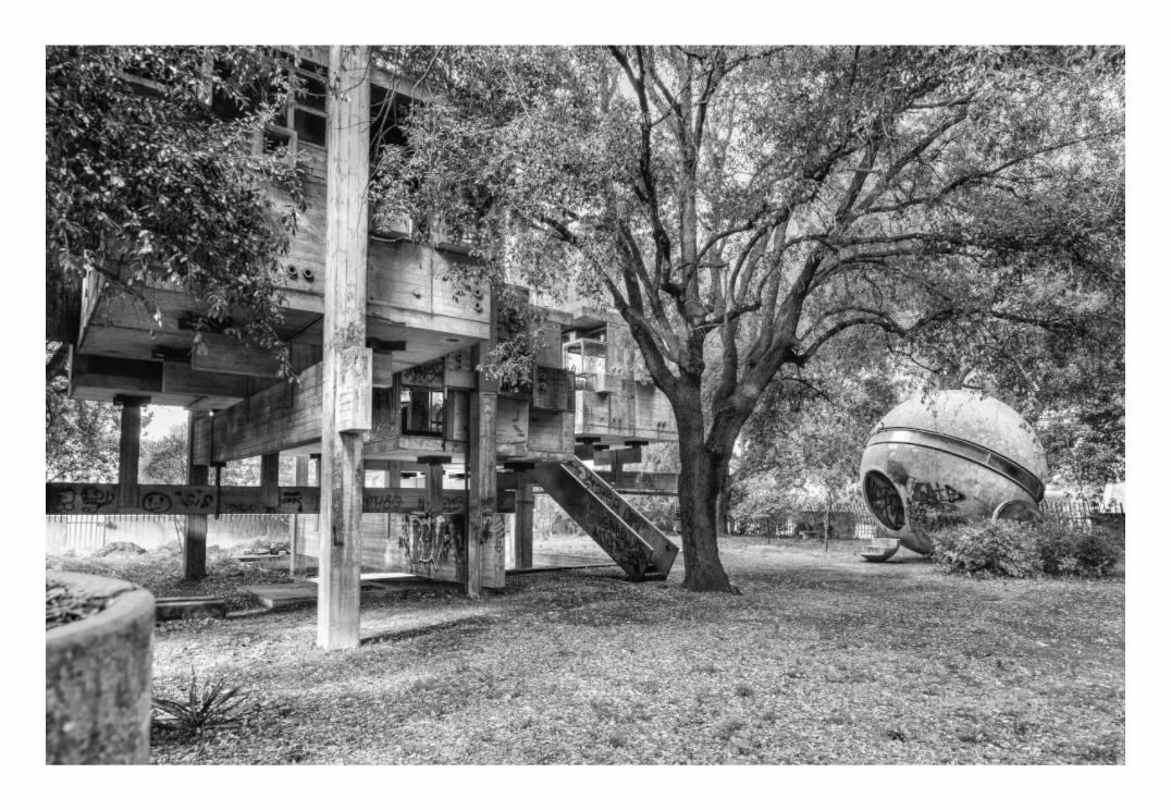 Modern architectural structure with a spherical building, Monochrome architectural abstract print emphasizing the decaying, interlocking geometric forms of Casa Sperimentale.