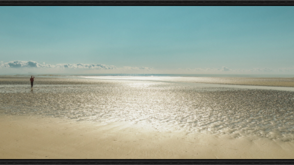 Main image Camber Sands Colour, Camber Sands at low tide, lone figure in red jacket on golden wet sand, minimalist coastal colour photography, serene East Sussex beach print, calm fine art wall decor